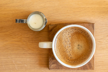 cup of coffee with milk jug