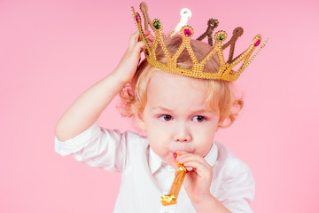 little blond boy with golden crown head curls hairstyle 4-5 year old in studio on pink background...
