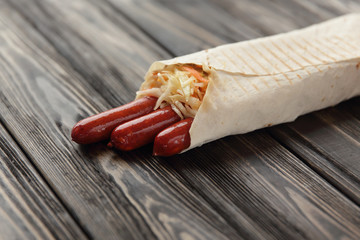 German sausages in pita bread on a dark wooden background.photo 