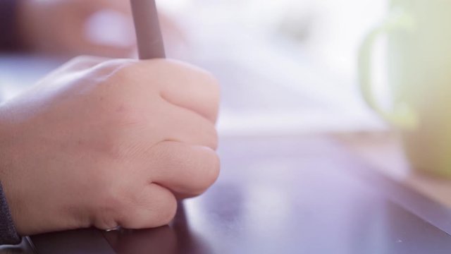 close up shot of a female hand using a drawing tablet