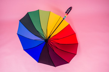 colorful rainbow umbrella on a pink background in the studio