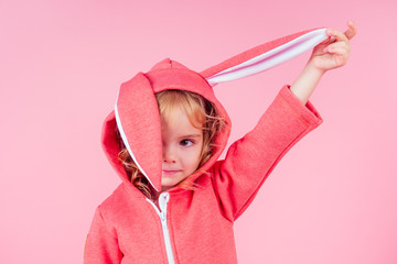 beautiful charming little girl curly blonde hairstyle wearing red sweater clothes with hood rabbit...