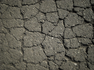 Old worn and cracked asphalt with cracks. Cracked asphalt background