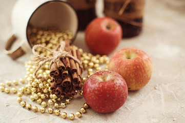 Festive composition mug with cinnamon, apples, candles and Christmas decoration