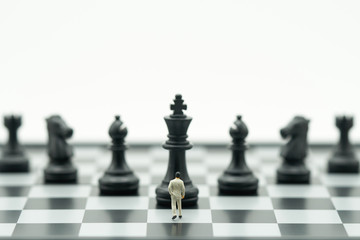 Miniature people businessmen standing Chess Analysis Communicate about business strategy. Or business planning using as background business concept and Strategy concept with copy space for your text.