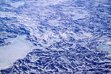 An aerial view of North Atlantic Ocean covered with mix of ice and snow. Nice water-snow-ice pattern is visible