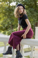 The girl in beret and skirt in the park