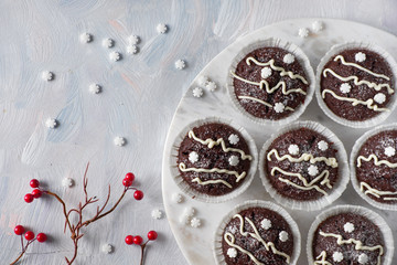 chocolate muffins in white paper cups decorated for Christmas