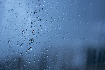 Water rain drop onto the window glass background.