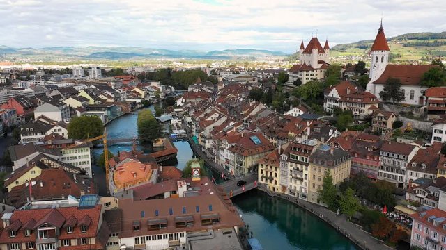 Aerial panoramic view of cityscape of Thun, picturesque town on river Aare, Thun Castle - landscape panorama of canton of Bern from above, Switzerland, Europe