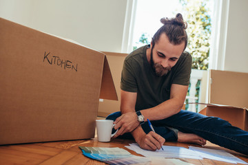 Man making a list of articles for packing