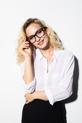 Happy blonde business woman in eyeglasses looking at the camera over white background