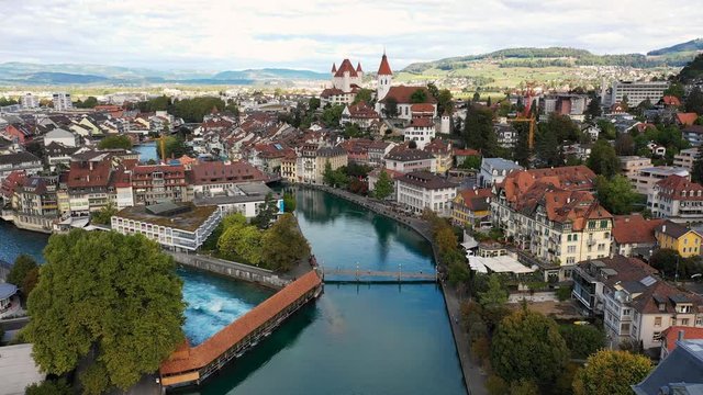 Aerial panoramic view of cityscape of Thun, picturesque town on river Aare, Thun Castle - landscape panorama of canton of Bern from above, Switzerland, Europe