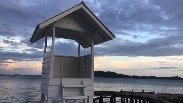lifeguard tower on the beach. Wood white pavilion at shore.
