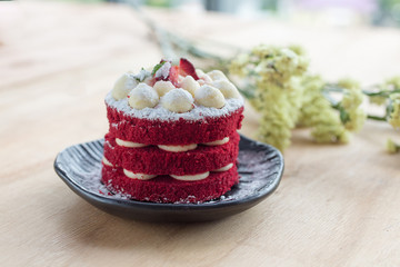 Thai Cake. Velvet red cake. Cookies decorated with red cake on wooden table and flower. strawberries moring. Delicious cake.