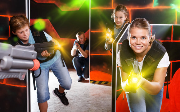 Woman playing lasertag with family