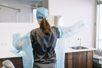 Portrait of a surgeon woman in sterile blue suit
