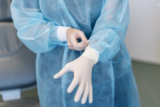 doctor putting gloves dressing to protect yourself from contagious disease virus concept