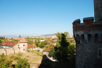 Defence tower of Corvin Castle with Hunedoara city view, Romania