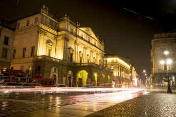 Fototapeta na wymiar Teatro alla Scala (Theatre La Scala) at night in Milan, Italy. Light trails of car traffic.