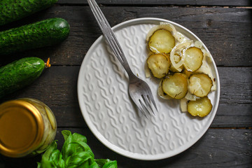 cucumber salad with onions in a plate on the table. top view. food background