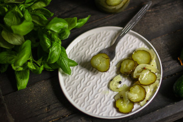 cucumber salad with onions in a plate on the table. top view. food background