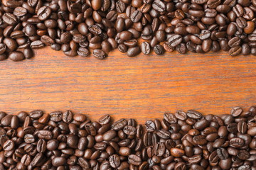 Coffee beans on wooden table with copy space for text or image.