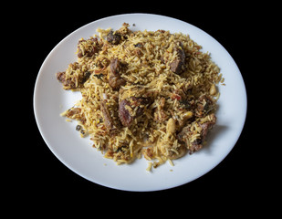 Cooked rice and meat served on a plate