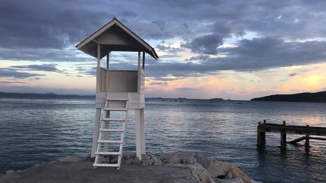lifeguard tower on the beach. Wood white pavilion at shore.
