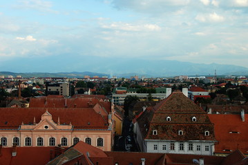 Fototapeta na wymiar Sibiu city rooftop panorama with Carpathian Mountains in the background, Romania
