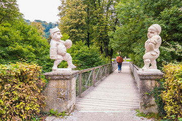Two white marble dwarfs at the entrance to the Dwarf Garden (Zwerglgarten) playing Pallone game....