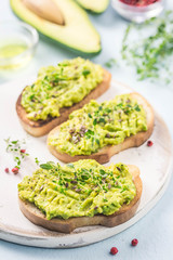 Smashed avocado sea salt and herbs toast. Selective fcous, space for text.