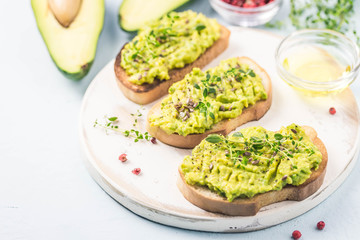 Smashed avocado sea salt and herbs toast. Selective fcous, space for text.