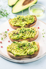 Smashed avocado sea salt and herbs toast. Selective fcous, space for text.