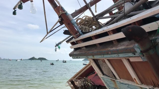 Fishing boats in the harbor. Shipwreck on the beach. An old wrecked wooden boat near the shore with the beach.