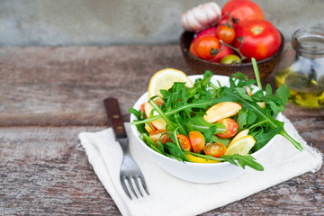 Fresh salad  arugula with tomatoes,apple  and mixed greens .