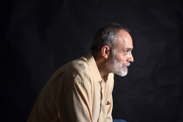 portrait of middle aged man on black