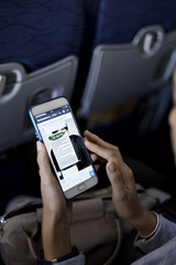 woman using smartphone airplane