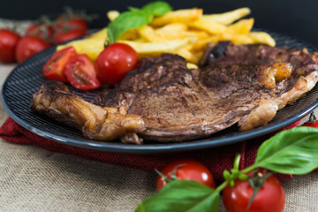 juicy steak beef meat with tomato and french fries