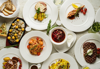 Different types of dishes on the table, top view. Concept for restaurant menu