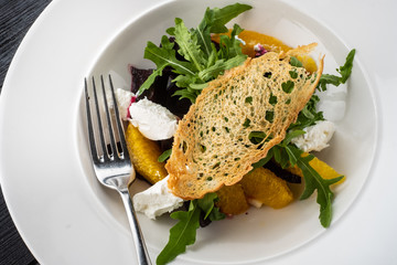 Salad with dried beetroot, apple, orange and soft goat cheese.