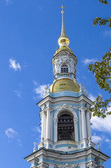 Fototapeta na wymiar fragment Of the bell tower of St. Nicholas Cathedral with a Golden spire and a cross, St. Petersburg