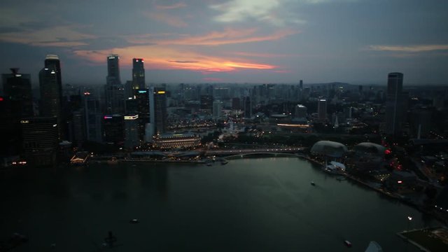 Panorama of Singapore Marina Bay with Financial District skyscrapers at sunset light reflected on the harbor. Singapore cityscape aerial view.