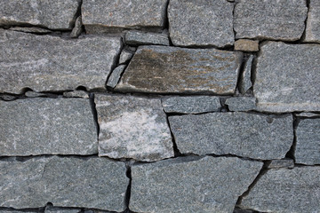 Granite rock blocks joined together forming wall in mountain refuge