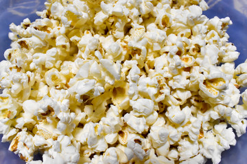 PLATE FULL OF WHITE AND YELLOW  POP CORN VERY TASTEFUL