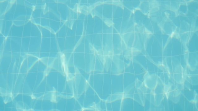  Wonderful background from turquoise waters moving and sparkling in a cheerful and beautiful way in a swimming pool on a sunny day in slow motion