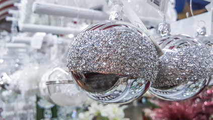 silver Christmas baubles exposed in a shop