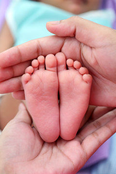 Close up of tiny feet of newborn baby