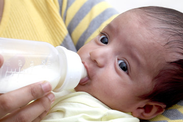 Mother feeding milk to newborn baby 