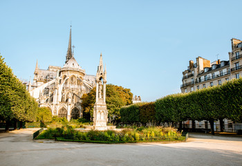 View on the baackyard of the famous Notre-Dame cathedral during the morning light in Paris, France